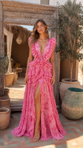 Front view of hot pink ruffle trim deep V maxi gown with front slit and waist cutouts