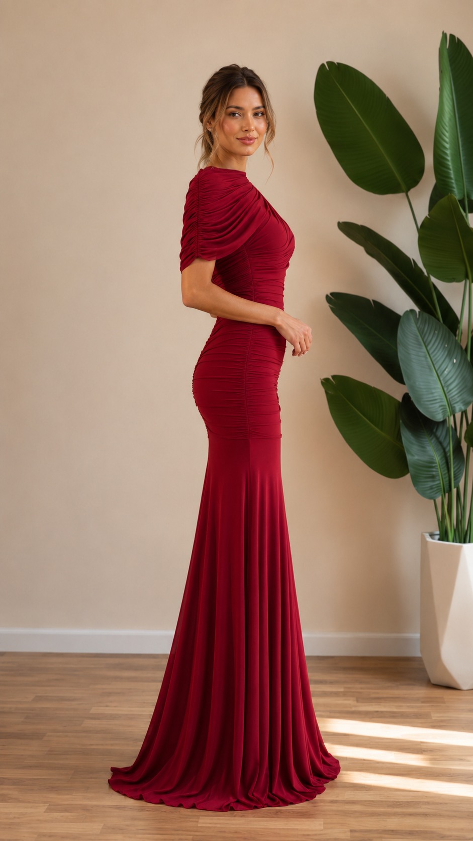 Side view of burgundy draped neckline mermaid evening gown