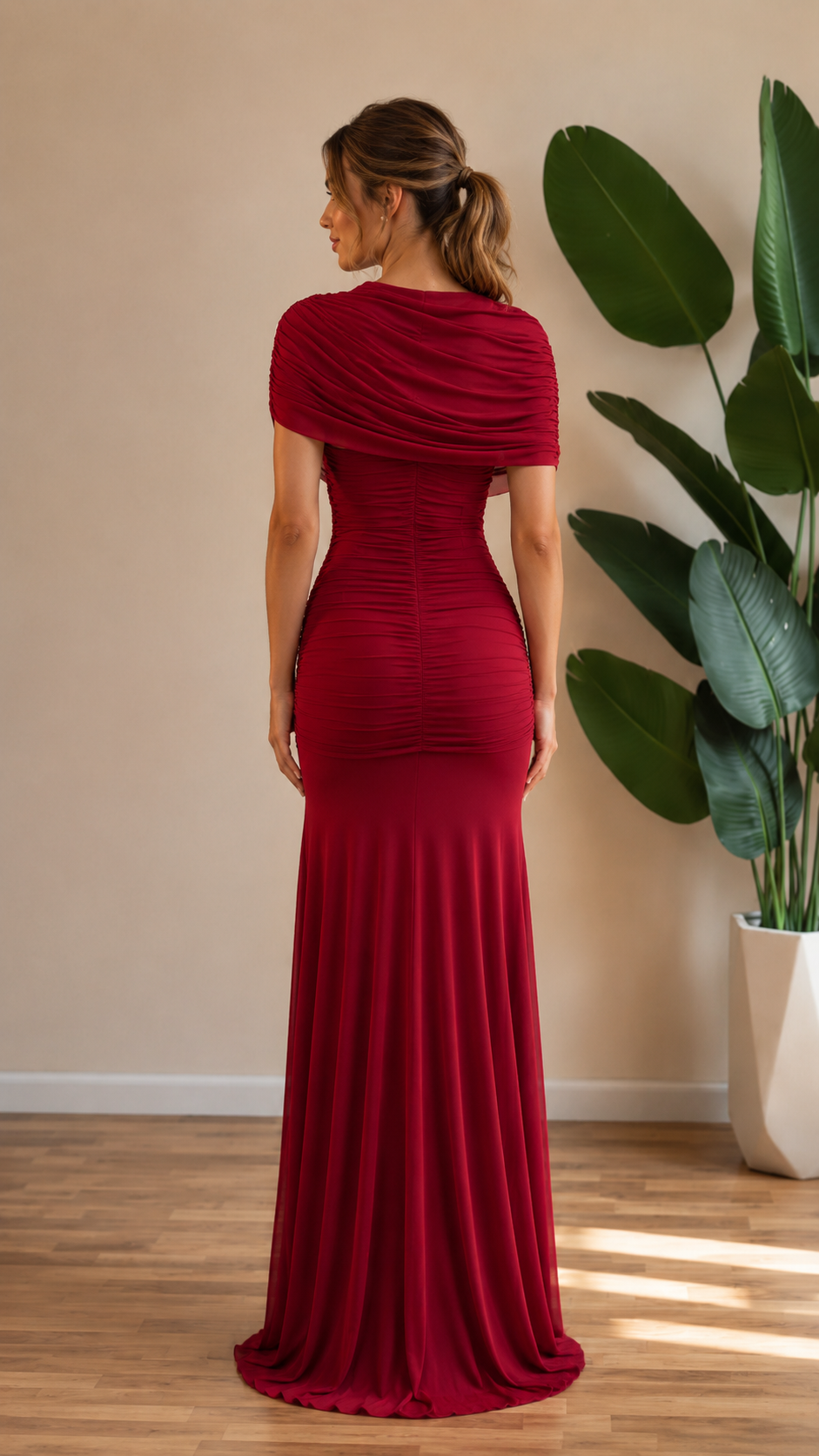 Back view of burgundy fitted ruched floor-length gown