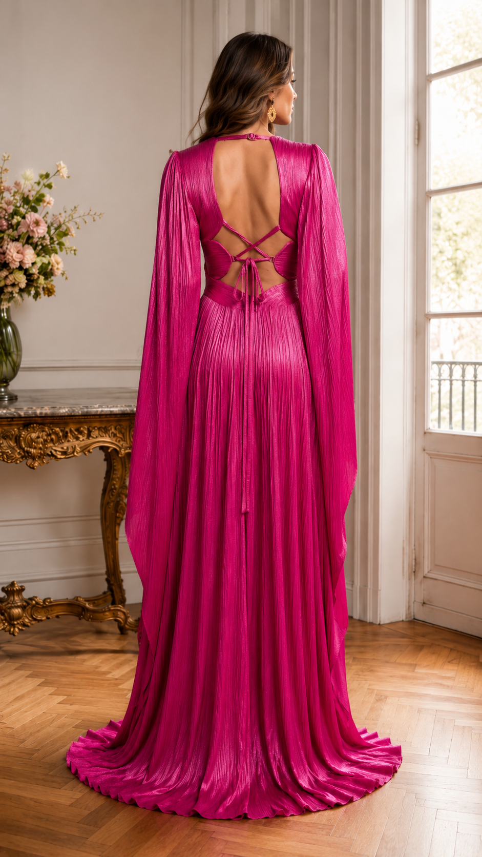 Back view of fuchsia pleated maxi gown with open back and lace-up detail