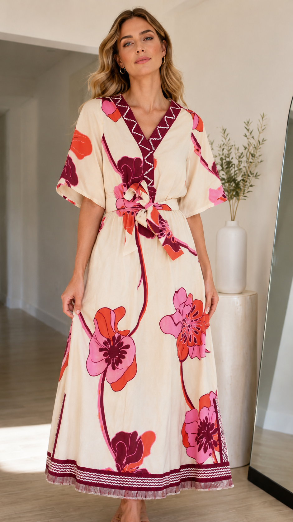 Close front view of cream floral V-neck maxi dress with contrast trim and waist tie