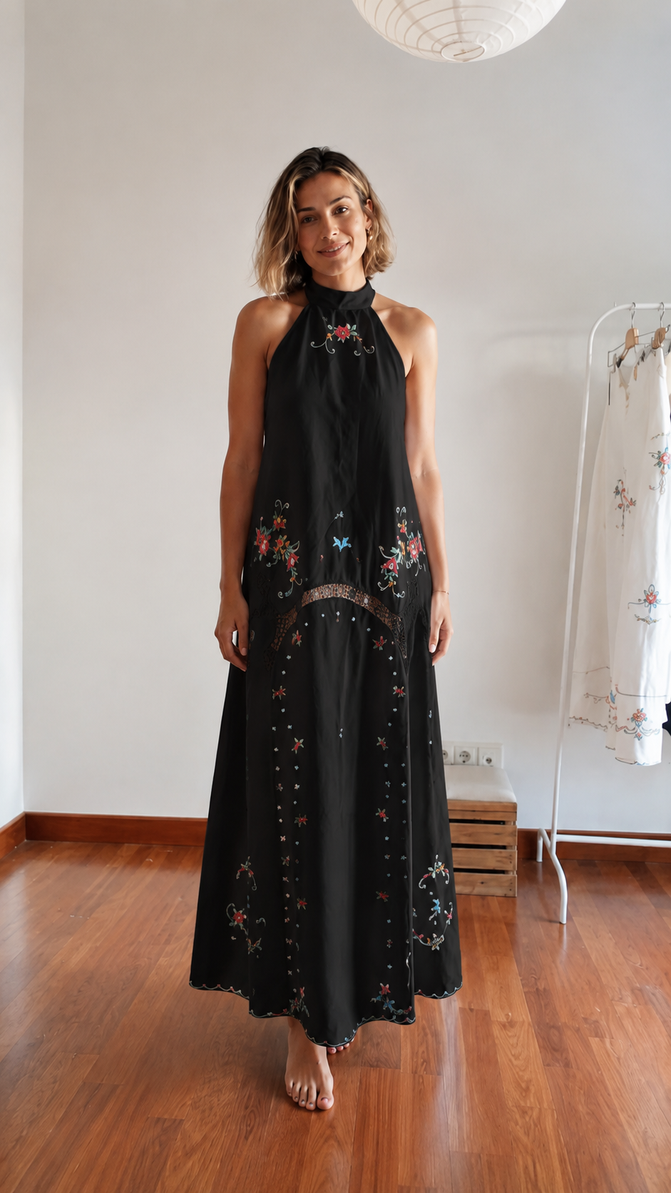 Front view of black embroidered halter maxi dress