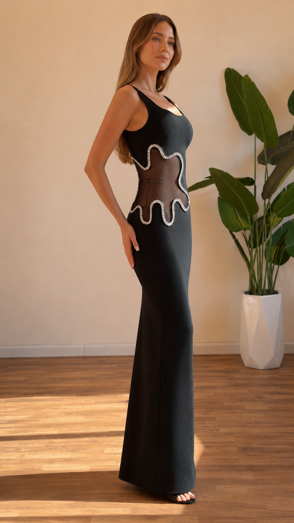 Side view of black square neck maxi dress with body-skimming fit and side cutout